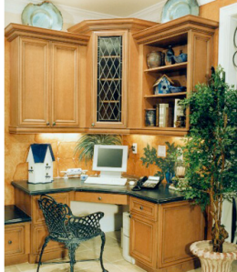 This home office is tucked into a kitchen nook. The plants are good feng shui, but it also needs a mirror since the worker's back is to the room.